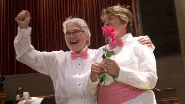 Barbra Schwartz, left, Julia Troxler celebrate after being married in a mass wedding at the Fulton County Government Centre on Friday in Atlanta.  