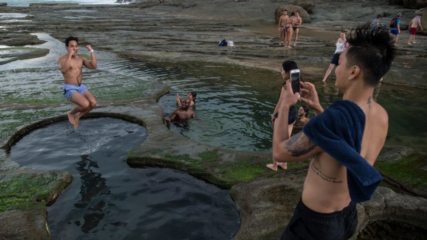 Tourists at the Figure Eight Pools in the Royal National Park.