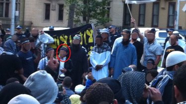 The boy arrested on Wednesday stands between his brother and his stepfather as he addresses the crowd in Hyde Park in 2012.