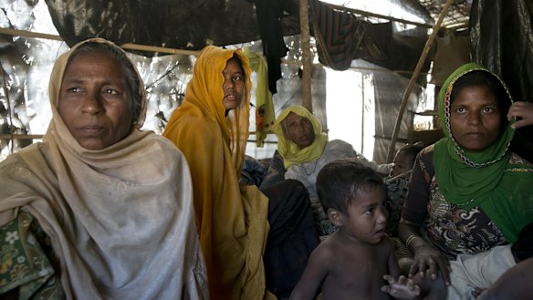 Women and children in a makeshift house they share with six others in a Rohingya refugee camp in Cox's Bazar, Bangladesh, after fleeing from Myanmar's Rakhine state.