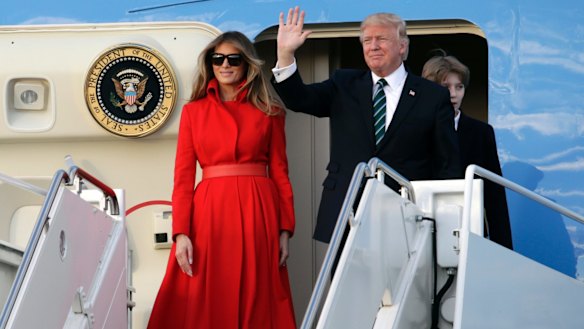 President Donald Trump waves from Air Force One with First Lady Melania.