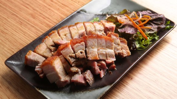 A platter of roasted pork belly with shatter-crisp crackling.