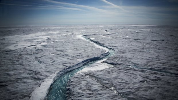 Meltwater flows along a supraglacial river on the Greenland ice sheet.