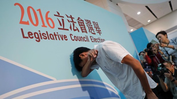 Radical activist candidate Eddie Chu cries after winning a seat in the legislative council elections.
