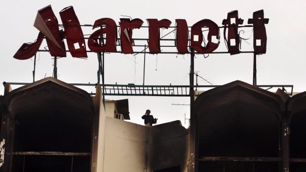 A Pakistani police officer stands on the roof of Marriott hotel in Islamabad a day after a truck bombing  on September 21, 2008. It was one of the biggest terrorist attacks in the country. 