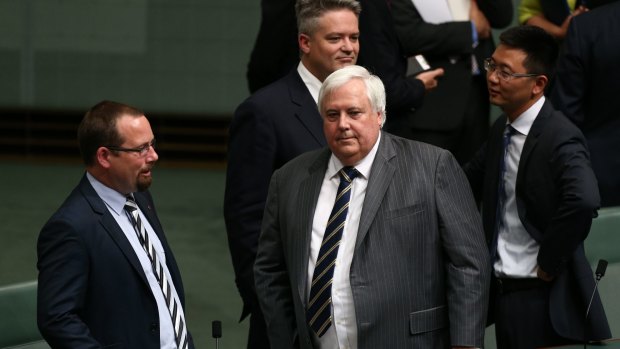 Clive Palmer talks to colleagues after  Chinese President Xi Jinping's recent address to parliament.