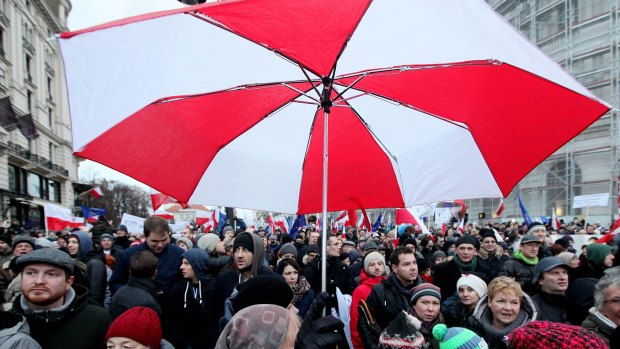 Tens of thousands of Poles angered by an ongoing constitutional conflict march in Warsaw, Poland.