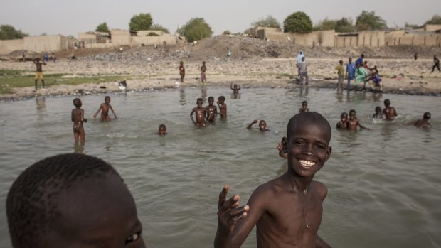 Children play by the river in Maiduguri, Nigeria. 