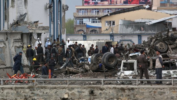 Afghan security forces inspect the aftermath of the bomb and gun attack in the capital.