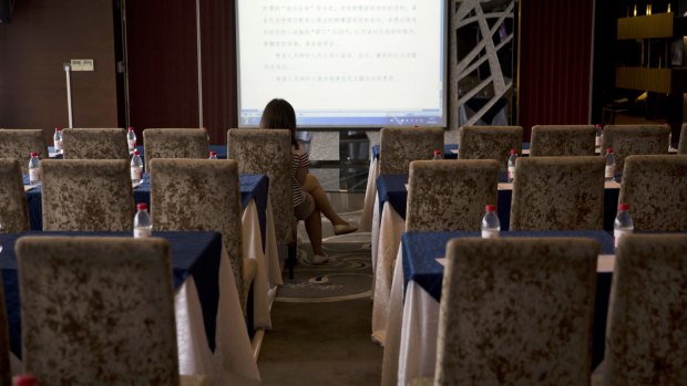 A lone reporter monitors what is supposedly the live court transcript displayed at a press centre near the Tianjin No. 2 Intermediate People's Court On August 2.
