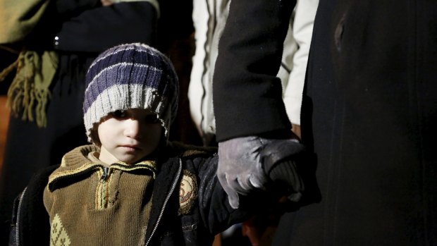 A Syrian boy with his family leaving Madaya on Monday. 