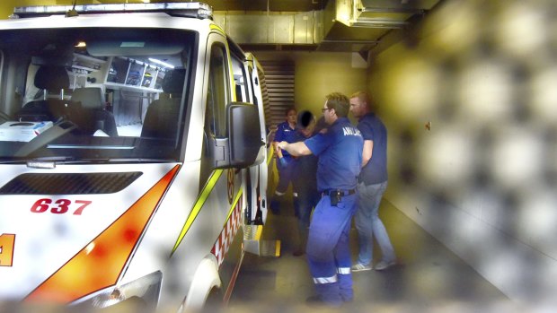 Gino Stocco is taken from Dubbo police station to hospital by ambulance.