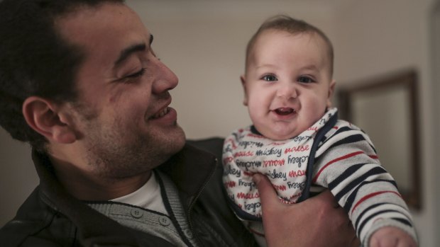 Baher Mohamed with his six-month-old son, Haroon, at his home in south-west Cairo.