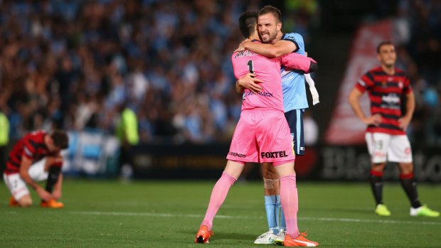 Winning embrace: Vedran Janjetovic and Matt Jurman celebrate Sydney FC's victory.