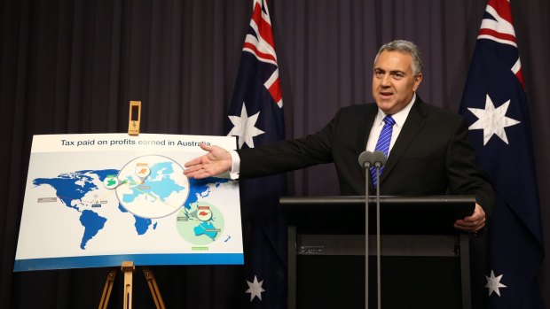 Be careful what you pose for: Joe Hockey points to a prop at a press conference in Canberra.