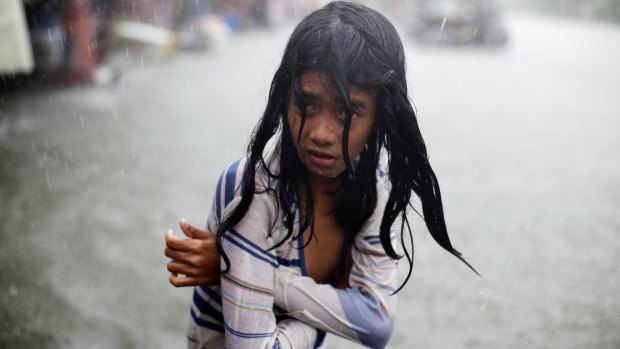 A Filipino girl tries to keep herself warm in Malabon, north of Manila, as typhoon Chan-hom passed the Philippines earlier this month.