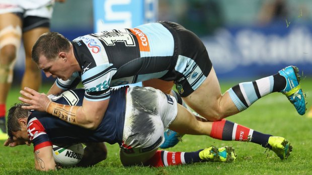 Sharks captain Paul Gallen tackles Mitchell Pearce of the Roosters in Cronulla's win on Monday night.