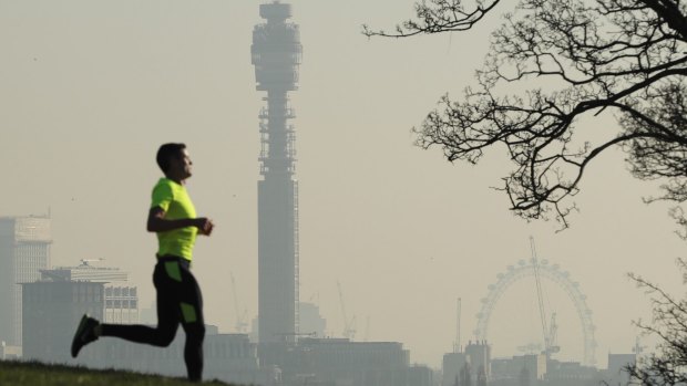 A jogger in Primrose Hill as smog covers the London skyline on January 24, 2017.