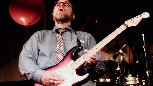 Paul Allen rocking out on the guitar in 1997.