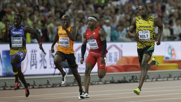 Levi Cadogan of Barbados, Churandy Martina of the Netherlands, Mike Rodgers of the US and Usain Bolt of Jamaica compete in the men's 100m heats at the World Athletics Championships in Beijing on Saturday.