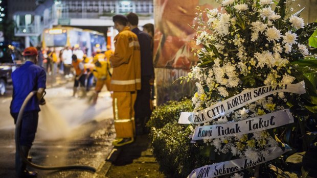 A bouquet of flowers is placed in front of the explosion site in the centre of Jakarta.
