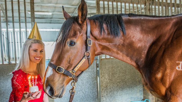 Ex-jockey Chynna Marston brings a birthday cake to Fell Swoop to celebrate the horse's birthday on August 1.