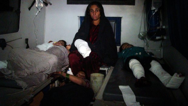 Injured Afghan children are treated at hospital in Helmand province, south of Kabul, after a rocket killed dozens. 
