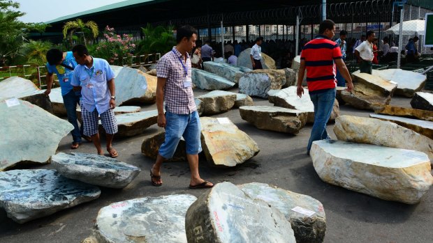 Merchants walk near jade stones displayed at annual Gems Emporium in the capital Naypyitaw, Myanmar this month. 