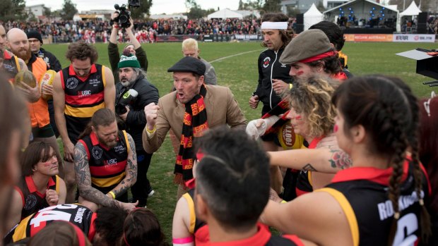 A bit of theatre: Reclink Community founder Jason Evans revs up the Rockdogs team at Victoria Park on Sunday.