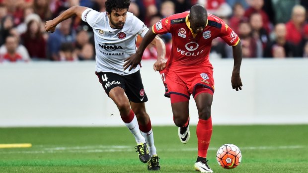 "It's a significant achievement and no one can take it away from us and we'll always remember this special team": Bruce Djite dribbles away from Nikolai Topor-Stanley.