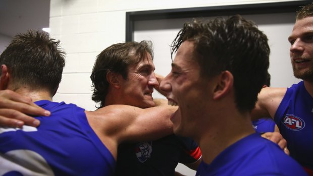 Western Bulldogs coach Luke Beveridge with a happy bunch of players after the win over the Sydney Swans in round five.