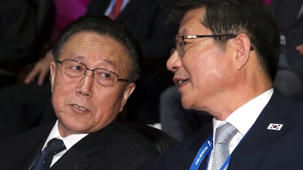 Senior North Korean official Kim Yang-gon (left) speaks with South Korean Unification Minister Ryoo Kihl-jae during the Asian Games closing ceremony at Incheon, South Korea, on Saturday.