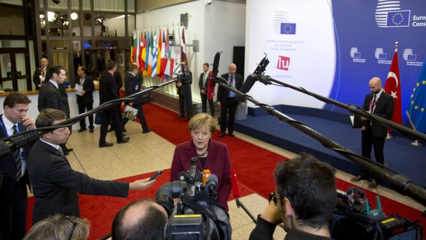 German Chancellor Angela Merkel speaks on arrival at the EU-Turkey summit in Brussels.