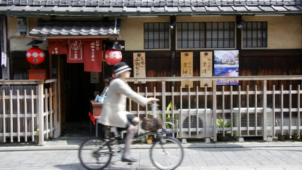 Cycling in Kyoto’s historic Gion district.