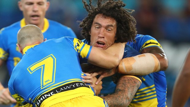 Kevin Proctor, centre, has stepped down as co-captain of the Gold Coast Titans and from playing duties.