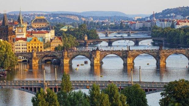  The Vltava River bridges shine in the setting sun.