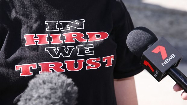 Essendon fans show their support for James Hird outside the Federal Court in Melbourne on Monday.