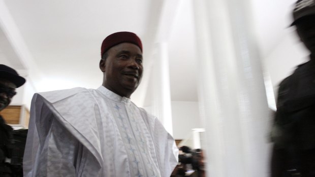 Niger President Mahamadou Issoufou prepares to cast his ballot during elections in Niamey on Sunday. 