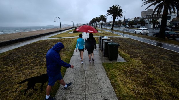 Heavy rain hits Melbourne: pedestrians in South Melbourne.