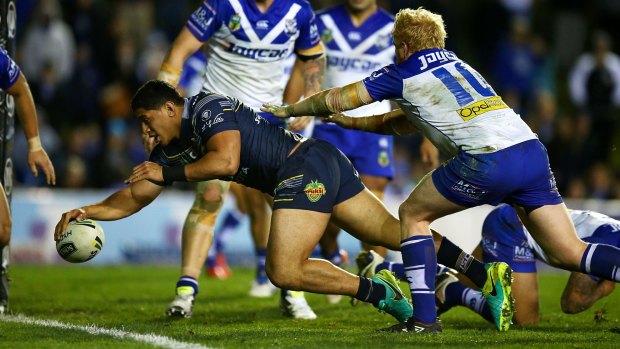 Unstoppable: Jason Taumalolo stretches to touch down for a try.