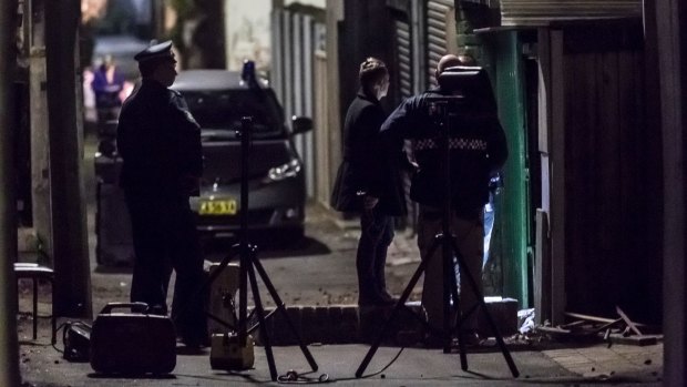 Police at the scene of the raid in Surry Hills on Saturday.