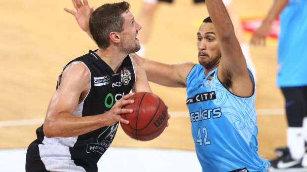 Melbourne United's Daniel Kickert fakes a shot on New Zealand's Tai Wesley.