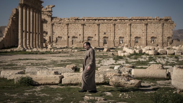 A man walks through the ruins of the Temple of Bel in Palmyra, Syria, last year. 