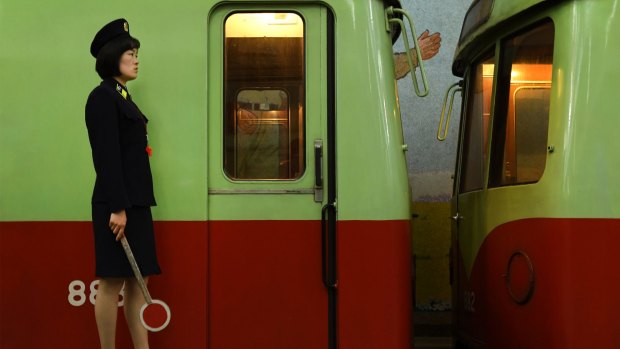A Metro police officer stands guard over a train at a station in Pyongyang, North Korea.