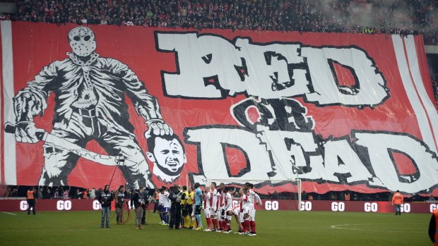 Standard Liege fans display a banner illustrating the decapitation of their former captain, Steven Defour.