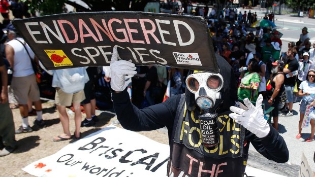 A man holds a placard during a protest against G20 leaders.