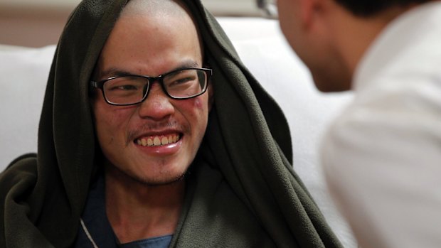 Taiwanese man Liang Sheng-yueh talks to a doctor at the Grande Hospital in Kathmandu.