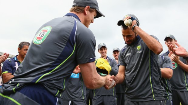 Proud moment: George Bailey hands Fawad Ahmed his first Australian international cap ahead of the T20 match against England in 2013.
