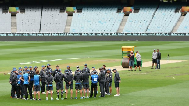 The New Zealand team huddle together on the MCG during a nets session.