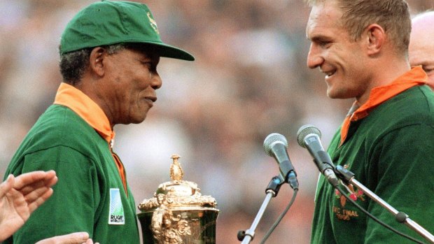 Nelson Mandela presents the trophy to South Africa captain Francois Pienaar at the 1995 World Cup.